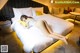 A woman laying on a bed in a hotel room.