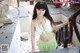 A woman in a green and white bikini posing for a picture.