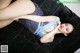 A woman laying on the floor in a blue lingerie.